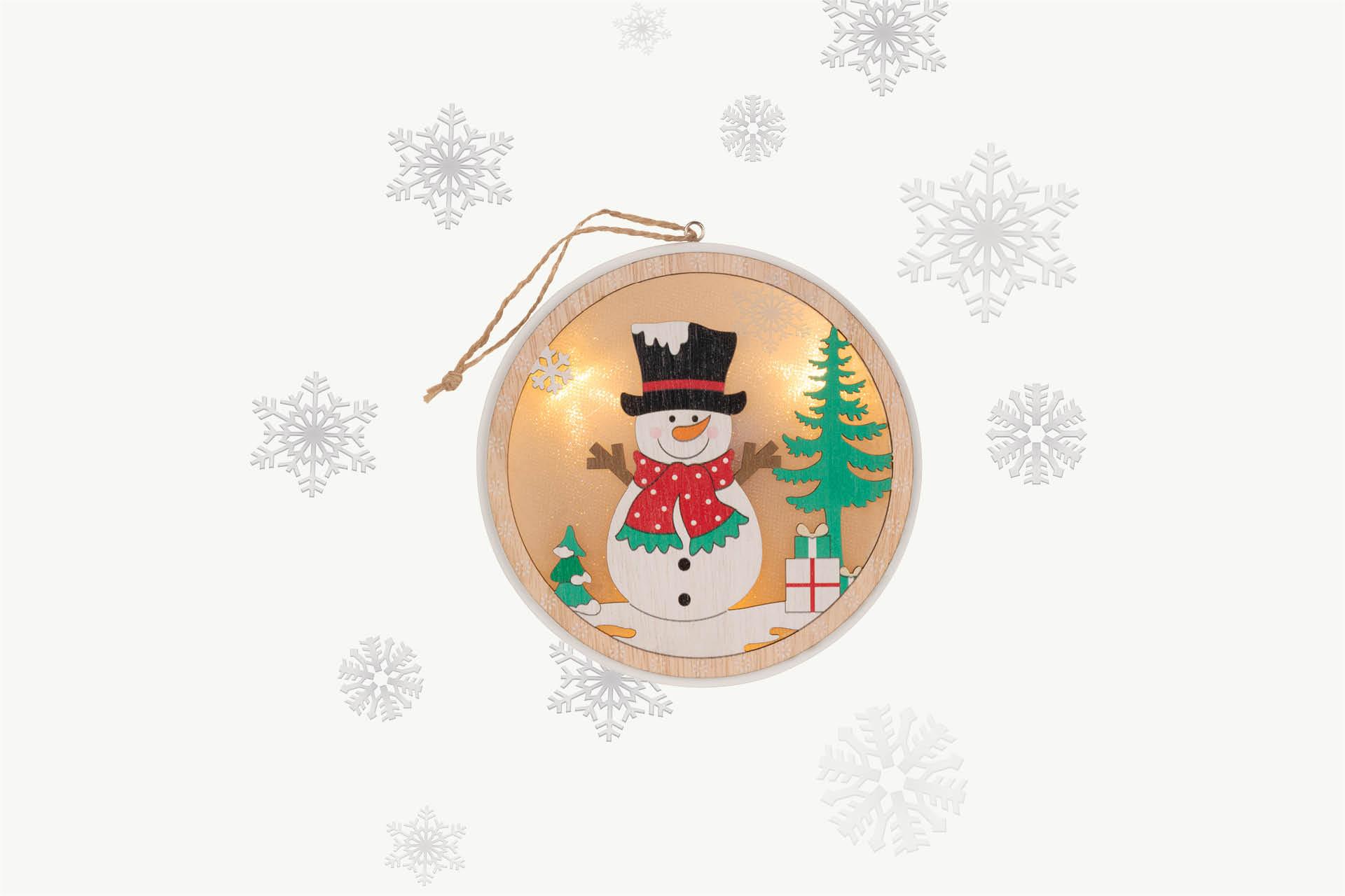 Lampe mit Schneemann und Schneeflocken im Hintergrund