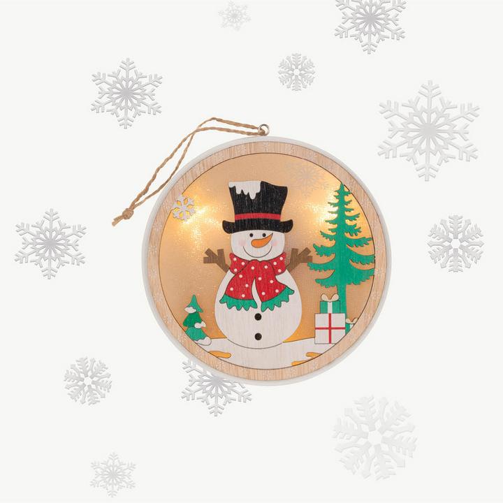 Lampe mit Schneemann und Schneeflocken im Hintergrund