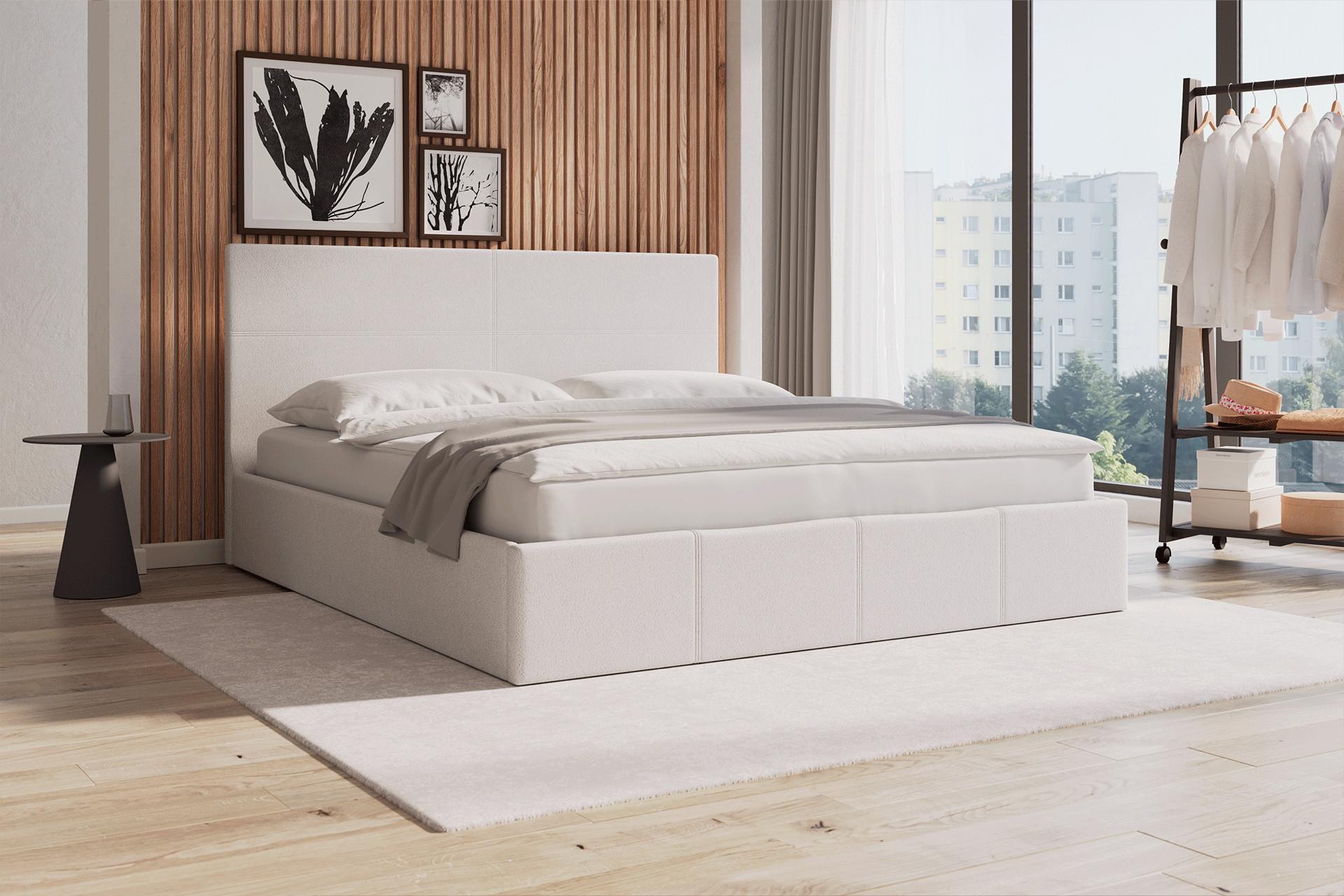Boxspringbett mit Kleiderständer und schöne Dekobilder an der Wand