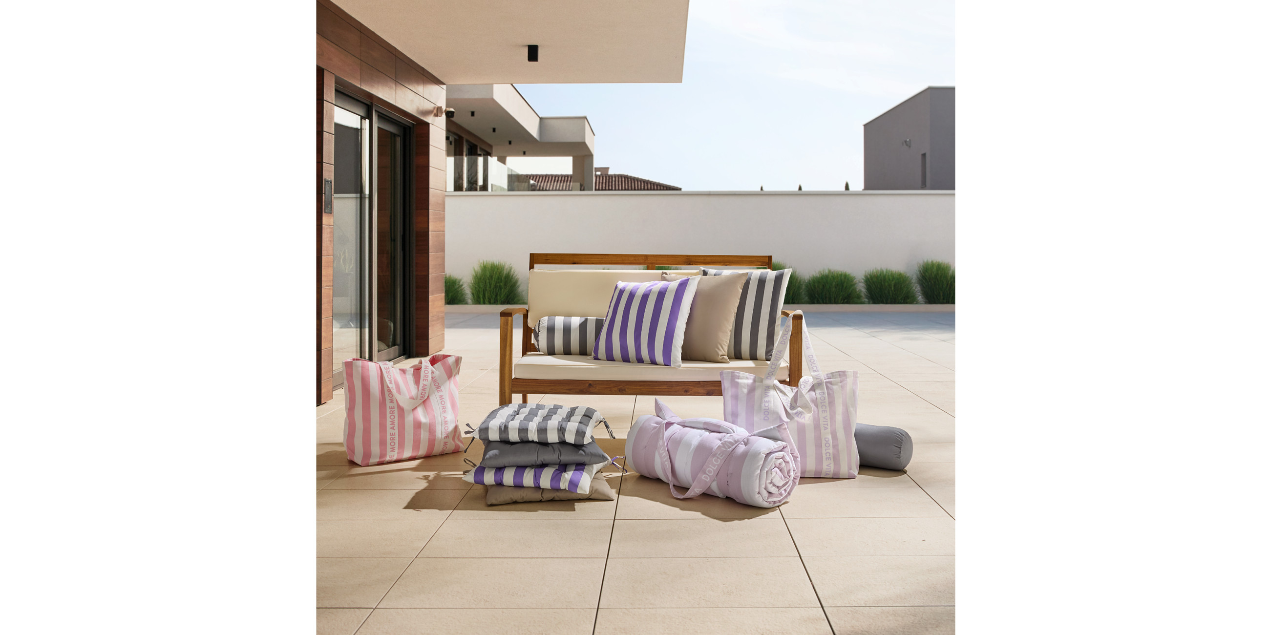 Loungesofa mit färbigen gestreiften Outdoor-Kissen und Stuhlauflagen